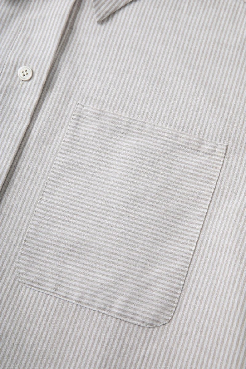 The French-style dress features a fitted long-length design Tracymade