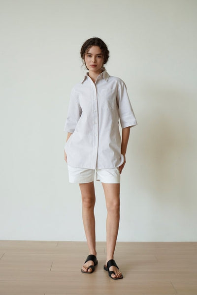 The French-style dress features a fitted long-length design Tracymade