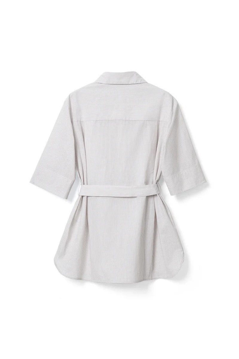 The French-style dress features a fitted long-length design Tracymade